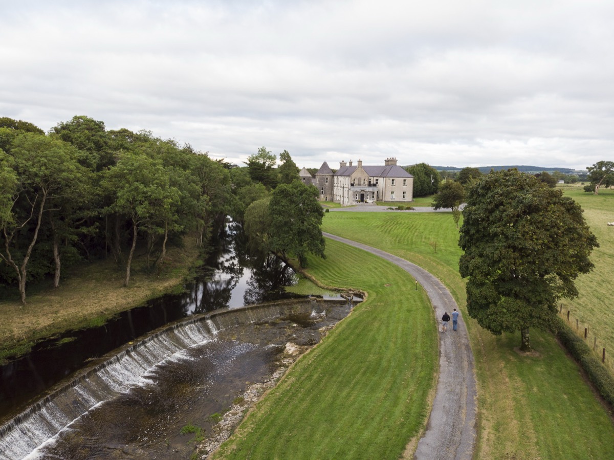 Aerial view of house, river and driveway